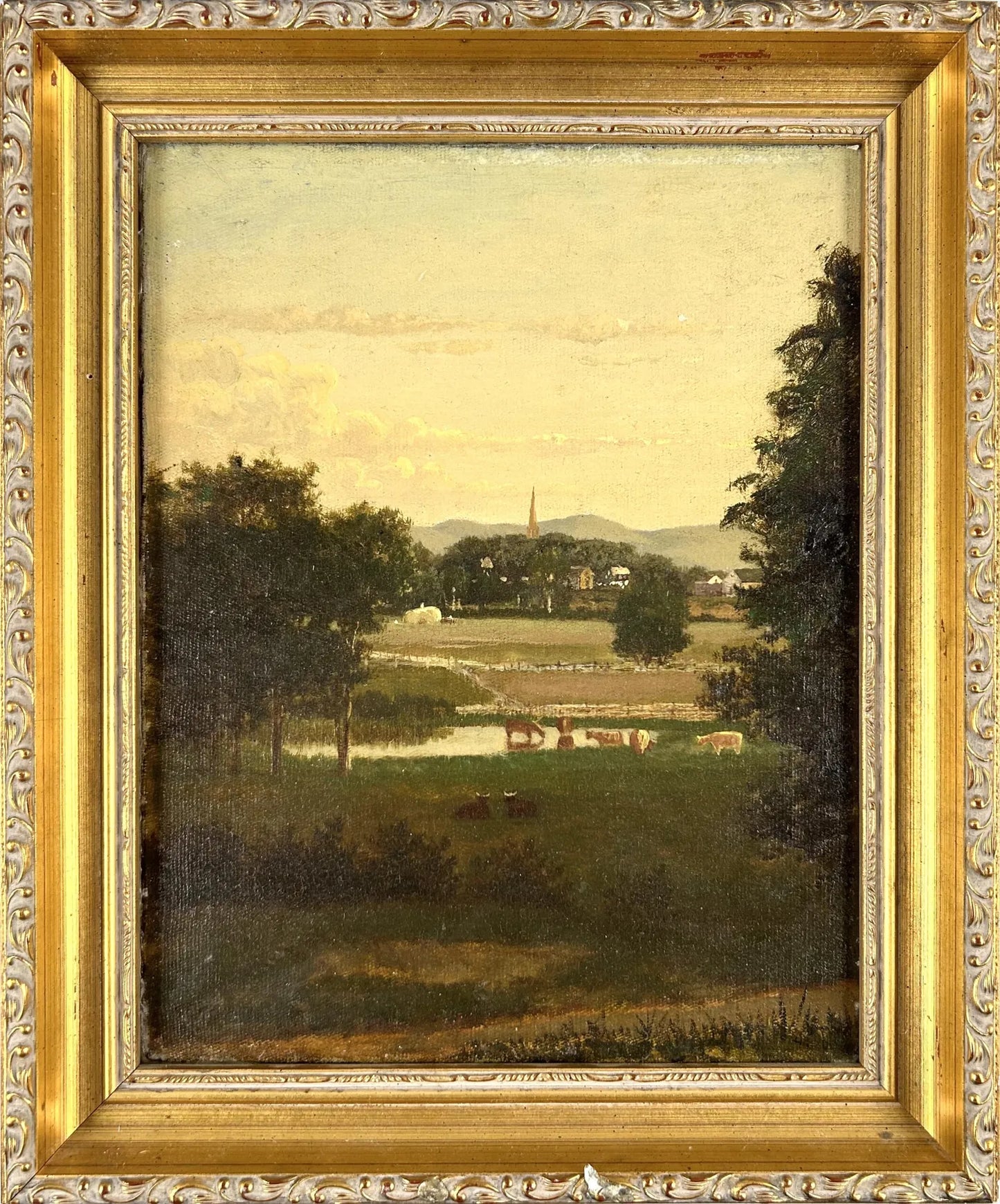 American School (19th Century) Cows in a field outside a village., Oil on canvas, 12" x 9.5".